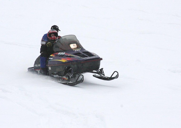 Heather Hasty/Valley Press Dustin Black, of Plains, brings in his sled with his son Brody, age 3, after participating in the poker run with both of his sons, Brody and Denny, age 2.