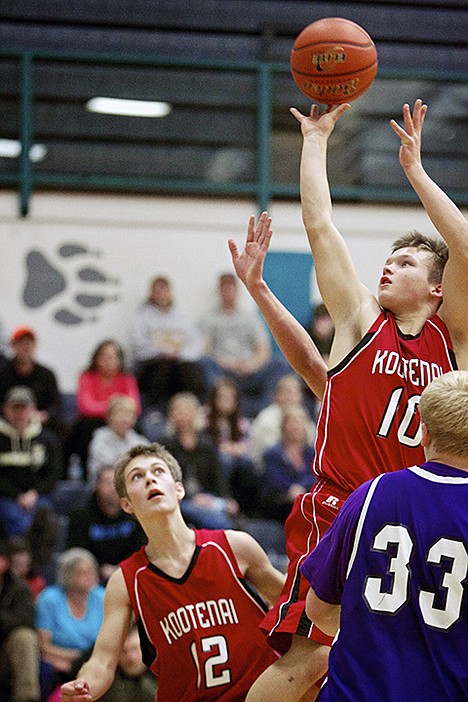 &lt;p&gt;Kootenai High's Morgon Willms elevates above the defense as he puts up a shot as his teammate Boone Benson gets in position for a rebound Monday during the second half of the 1A Division II District 1 tournament held at Lake City High.&lt;/p&gt;