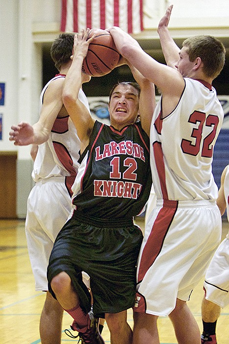 &lt;p&gt;Lakeside High's Leighton Boyd gets fouled as he drives the lane between Jon Dellinger, right, and Jake Kellinger from Wallace High during the first half of Tuesday's 1A Division I District 1 tournament.&lt;/p&gt;