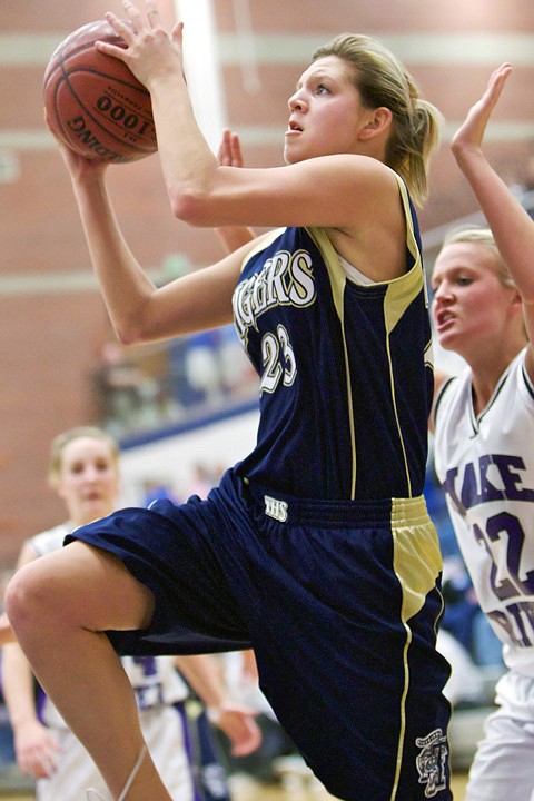 &lt;p&gt;Timberlake High's Caitlyn Nichols drives to the hoop in front of Snake River High defenders during the first half of the 3A semi-final state basketball game Friday in Nampa.&lt;/p&gt;