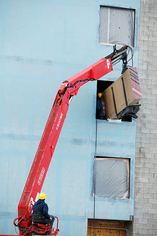 &lt;p&gt;Construction continues on the Hilton Homewood Suites as workers move sheets of drywall through a window Wednesday morning. The four-story hotel in Hutton Ranch Plaza is expected to open this summer.&lt;/p&gt;