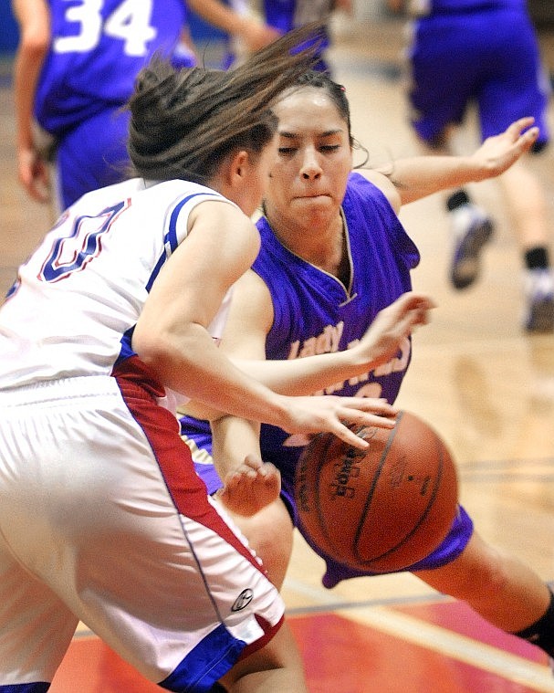 Polson junior Sierra Pete (20) puts pressure on Columbia Falls junior Danielle Gilley (10) as she moves the ball down the court during their game on Thursday night.