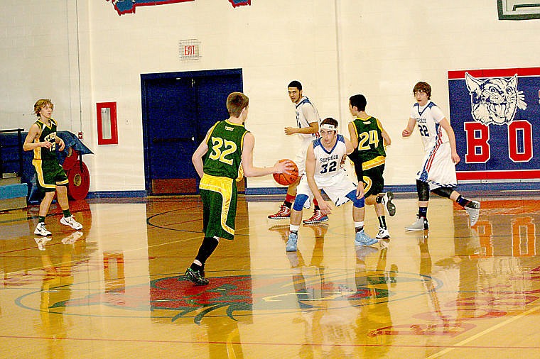 <p>Tiger Dakota Wickham rushes the Superior guards, headed by Bobcat Wyatt Zylawy, in his last game of the regular season.</p>