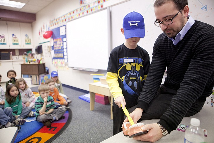 &lt;p&gt;Dr. Cameron Clark, right, teaches Josh Desch the proper way
brush his teeth during a dental hygiene presentation at Edgerton
Elementary School.&lt;/p&gt;