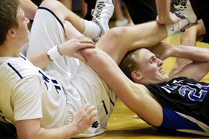 &lt;p&gt;JEROME A. POLLOS/Press Coeur d'Alene High's Tony Nacarrato gets tangled with two Lake City High players during the first half.&lt;/p&gt;