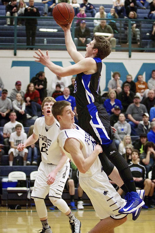 &lt;p&gt;JEROME A. POLLOS/Press Coeur d'Alene High's Colby Daniels goes up and over Drew Hocking from Lake City High for a shot in the second half.&lt;/p&gt;