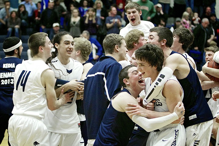 &lt;p&gt;JEROME A. POLLOS/Press Lake City High's Justin Pratt is swarmed by his classmates after the Timberwolves defeated Coeur d'Alene High in the 5A Region 1 tournament championship game Tuesday with a final of 58-33.&lt;/p&gt;