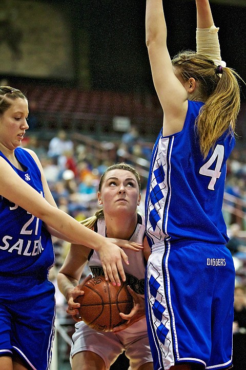 <p>Timberlake High's Cassie Thompson looks up toward the hoop between Sugar-Salem's Mikailei Inns, left, and Georgia Brown.</p>