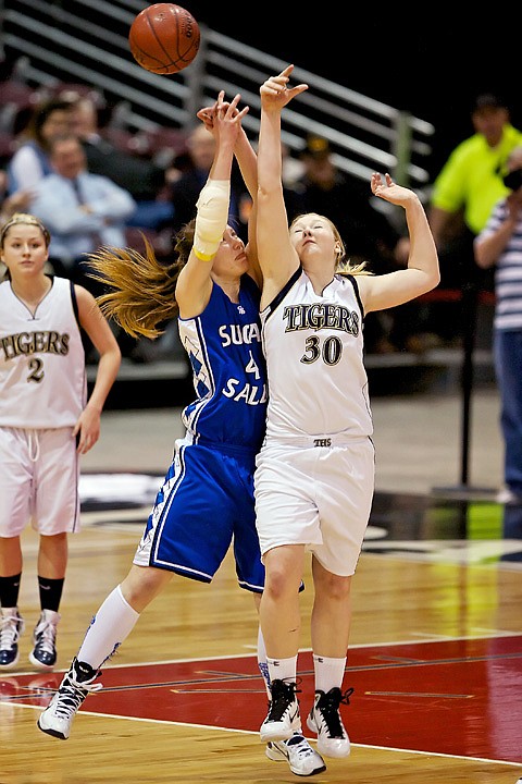 <p>Timberlake High's Ashley Peters, right, collides into Georgia Brown from Sugar-Salem as they went for a loose ball during the first half of the 3A state basketball championship game at the Idaho Center in Nampa.</p>