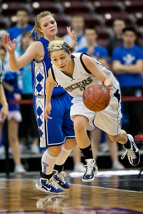 <p>Timberlake High's Kara Wenstrom flies past McKall Miller from Sugar-Salem High and avoids stepping out of bounds during the second half.</p>