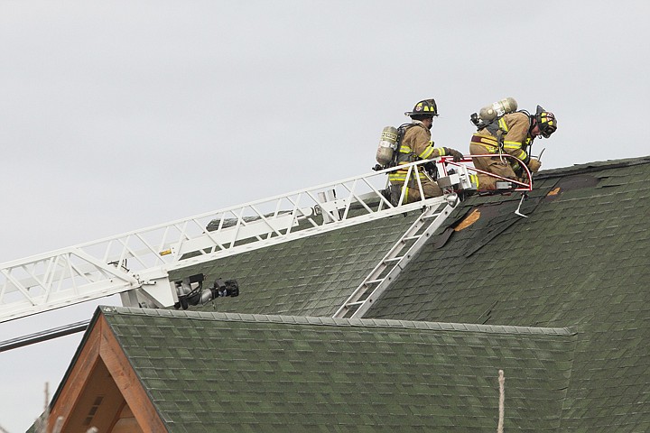 &lt;p&gt;Trying to find hot spots in the roof, firefighters work from the
ladder of a Kalispell Fire Department truck at the scene of a house
fire near Whitefish on Wednesday morning.&lt;/p&gt;