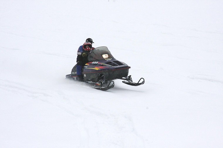 Heather Hasty/Valley Press Dustin Black, of Plains, brings in his sled with his son Brody, age 3, after participating in the poker run with both of his sons, Brody and Denny, age 2.