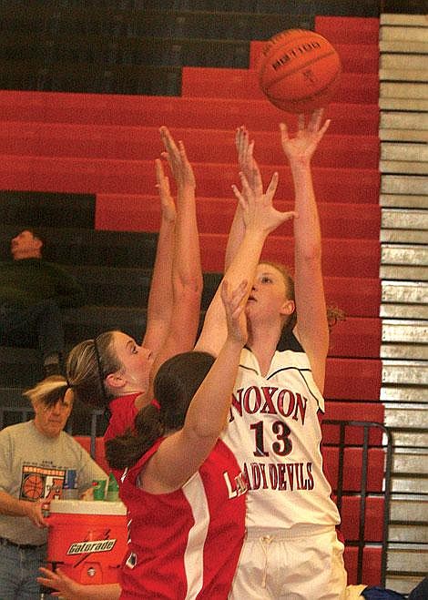 Photo by Aaric Bryan&lt;br&gt;Lady Red Devil Lindsey Franz goes up for a shot over Bobcats Shannon Frederick and Shanna Stephens at the 14-C District Tournament in Ronan Thursday.