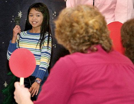 Photo by Adam Herrenbruck&lt;br&gt;Fifth-grader Shailyne Ames reacts as the judges show her she correctly spelled the word conductor. Ames finished third.