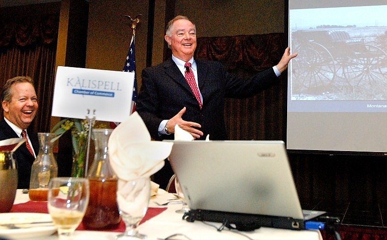 Kalispell Chamber of Commerce President Joe Unterreiner, left, laughs while Semitool founder Ray Thompson displays a slide of an old carriage during his presentation Tuesday tracing more than 30 years of business experience.