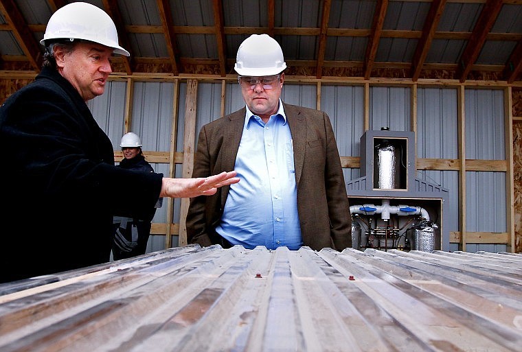 Michael Smith, president of Algae Aqua-Culture Technologies, shows U.S. Sen. Jon Tester a scale model of a biomass co-generation plant at the F.H. Stoltze Land and Lumber Co. mill near Columbia Falls on Monday morning.