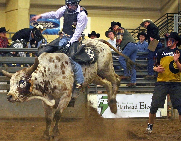 Ross Lewis of Beulah, N.D., stays on his bull during the first day of the Rocky Mountain Extreme Bull Riding Challenge 2010 at Majestic Valley Arena Friday evening.