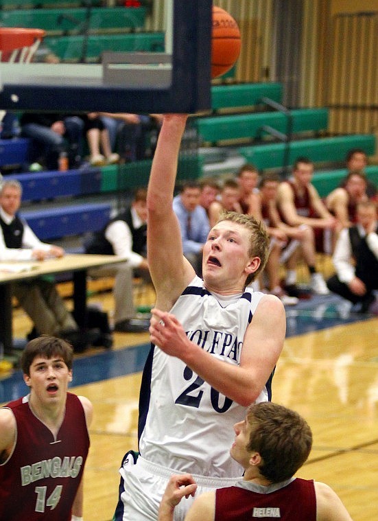 Glacier's Colter Hanson lifts up a shot as Helena High's Graham Bogumill (14) and Tyler Wiedeman look on in the second half of Friday evening's game in Kalispell. Hanson scored a career high of 19 points against the Bengals.