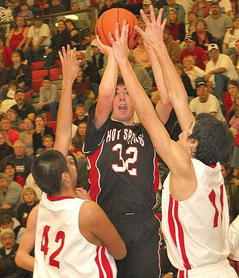 Photo by Aaric Bryan&lt;br&gt;Savage Heat sophomore Reiley Winebrenner shoots through a crowd of Two Eagle River defenders in the 14-C District championship game at the Ronan Event Center. Winebrenner finished with 31 points, including six 3-pointers. Hot Springs claimed a 60-53 victory over Two Eagle.