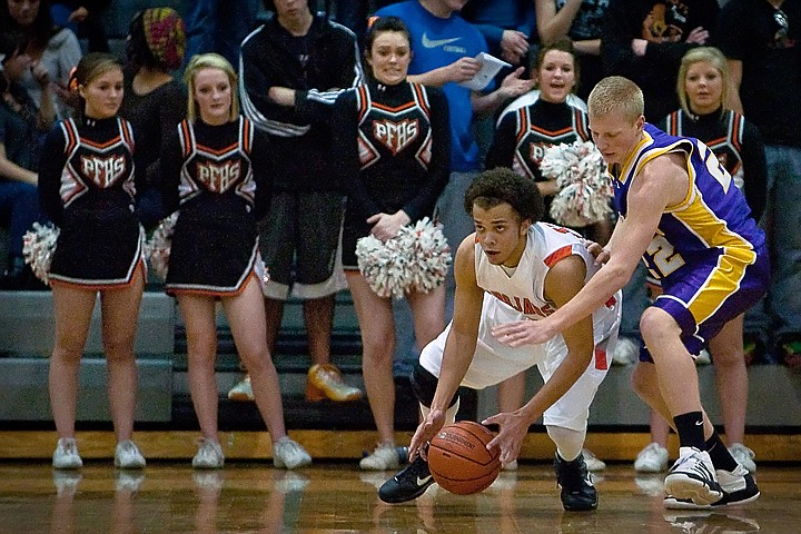 &lt;p&gt;Malcom Colbert from Post Falls High looks to make a pass down court as he falls after beating Lewiston High's Brian Taylor to the ball.&lt;/p&gt;