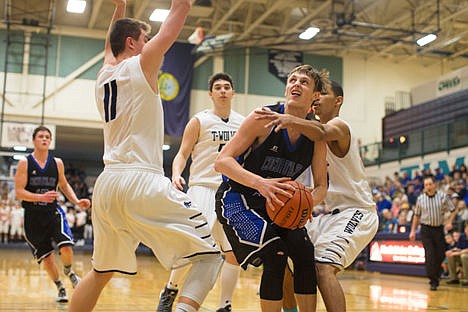 &lt;p&gt;Tony Naccarato, Coeur d'Alene High School, drives right through Lake City's Jeramy Hughes, right, for the shot on Friday night at the 5A Region 1 opener at Lake City High School.&lt;/p&gt;