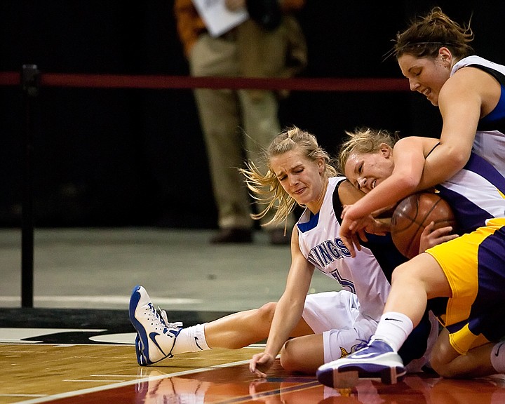 &lt;p&gt;Coeur d'Alene's Amanda Buttrey, left, and Carli Rosenthal, top, fight Lewiston's Jessica Kramer for a loose ball during the first half Saturday in Nampa.&lt;/p&gt;