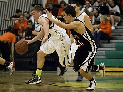 &lt;p&gt;Johnny Hayden, of Timberlake, sprints up the court past Priest River's Dalton Sommer in the second half.&lt;/p&gt;