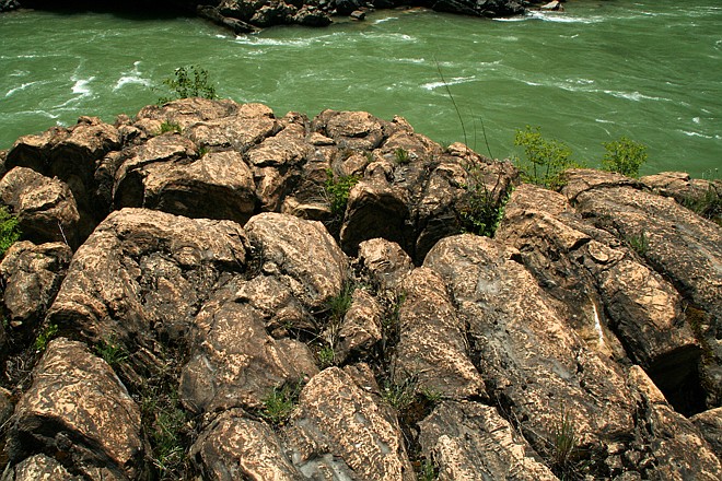 &lt;p&gt;The irregular lumps of rock at the base of the Kootenai River swinging bridge upstream of Troy, Montana are fossilized stromatolites. Close inspection reveals the internal layers of stromatolites which were created by cyanobacteria.&lt;/p&gt;