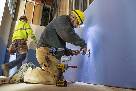 &lt;p&gt;Ryan Asker of Mountain States Electrical, installs wiring for some outlets in one of the bathrooms in the new Winton Elementary School site on Friday in Coeur d'Alene.&lt;/p&gt;