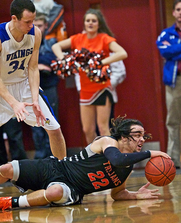<p>JEROME A. POLLOS/Press Post Falls High's Marcus Colbert looks for a teammate to pass to after diving for a loose ball in front of Ty Higbie from Coeur d'Alene High in the second half.</p>
