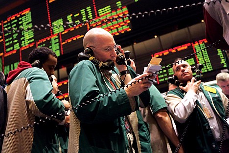 &lt;p&gt;Traders work the crude oil options pit at the New York Mercantile Exchange Thursday in New York. An unexpected indication from the U.S. Federal Reserve that it is considering how to bring an end to its super-easy monetary policy rattled markets Thursday. While supposedly riskier assets such as stocks, the euro and oil prices fell sharply, the perceived safer financial assets, such as the dollar and German government bonds, were in demand.&lt;/p&gt;