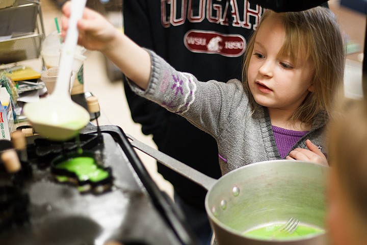 &lt;p&gt;Five-year-old Jesalyn Meyers pours green eggs into a mold as part of a Dr. Seuss birthday party celebration at The Cottage.&lt;/p&gt;