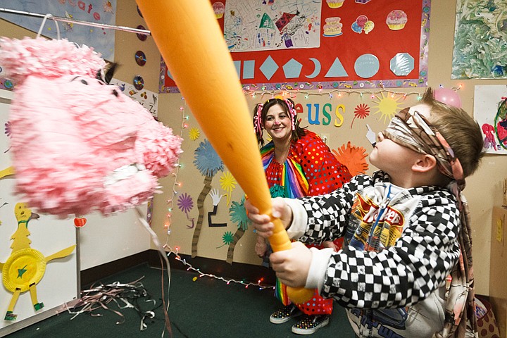 &lt;p&gt;Dominic Lari, 3, swings a bat at a pink poodle pinata Monday during a birthday celebration for popular children's author Dr. Seuss at The Cottage Childcare and Learning Center in Post Falls. Included in the festivities was Bubble Gum the clown, played by Johanna Byers, background.&lt;/p&gt;