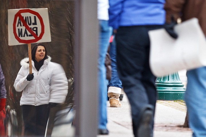 &lt;p&gt;Winton Elementary School teacher Kim Lutes is reflected in a store window with a protest sign as she marches from city hall to the Human Rights Education Institute with a crowd of educators from area school districts.&lt;/p&gt;