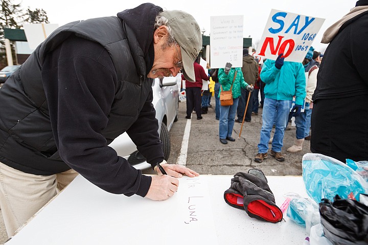 &lt;p&gt;Boundary County high school social studies instructor Daniel Butler creates a protest sign before a teachers rally in Coeur d'Alene.&lt;/p&gt;