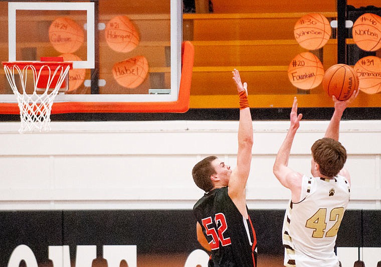 &lt;p&gt;Helena Capital senior Carson Dummer (42) shoots over Flathead senior Matt Quist (52) Saturday afternoon during Western AA basketball action at Flathead High School.&lt;/p&gt;