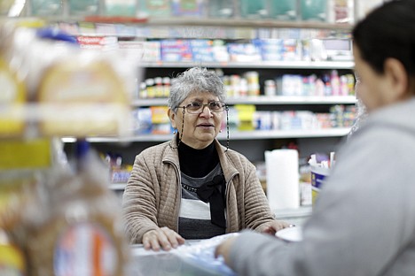 &lt;p&gt;Karina Cruz, center, owner of the Indiana Food Market helps a customer, Jan. 15, in Philadelphia.&lt;/p&gt;