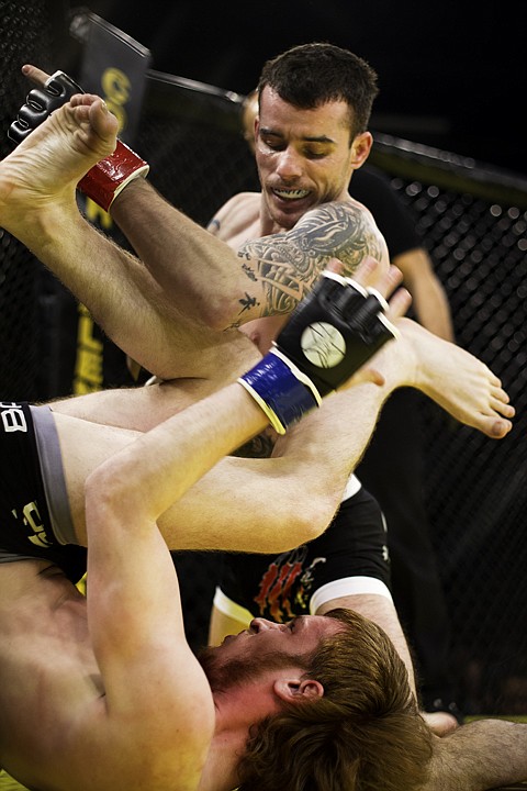 &lt;p&gt;SHAWN GUST/Press Zach Lari, of Post Falls, throws a knee to the head after putting Elliot Gillbert to his back during the 135-pound bout in Worley.&lt;/p&gt;