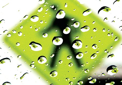 &lt;p&gt;A pedestrian crossing sign is reflected in rain drops Friday, Feb. 22, 2013, as a shower passes through the Tri-Cities region of Washington.&lt;/p&gt;