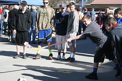 &lt;p&gt;Austin Runkle, 12, of Spirit Lake, smacks a soccer ball into a goal using a hockey stick Sunday at Winterfest on Maine Street in Spirit Lake.&lt;/p&gt;