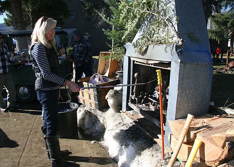 &lt;p&gt;Shari Simpson of Spirit Lake roasts a hot dog in a fireplace that was landscaped into a snowbank for Winterfest.&#160;&lt;/p&gt;