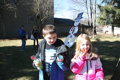 &lt;p&gt;Hunter Johnson, 9, and Lily Bole, 7, both of Athol, show off colorful ice cubes they collected during the colored ice cube scramble Sunday in Spirit Lake.&lt;/p&gt;