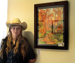 Tara Mathers, 18, a senior at Plains High School, stands next to her painting hanging at the Clark Fork Valley Hospital's &quot;Art on the Walls&quot; exhibit.  Mathers mainly does western style art, and started her own business called &quot;Crazy MT Cowgirl Art&quot; in 2010.