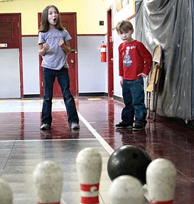 Sarah Smith, 7, a first grader at Paradise School, and her brother Thor Smith, 4, bowl at the Paradise school carnival on last Thursday night.  Families and kids played games and tried their chances at the cakewalk and raffle.  The cakewalk and carnival was a fundraiser to raise money for the eighth graders graduation.