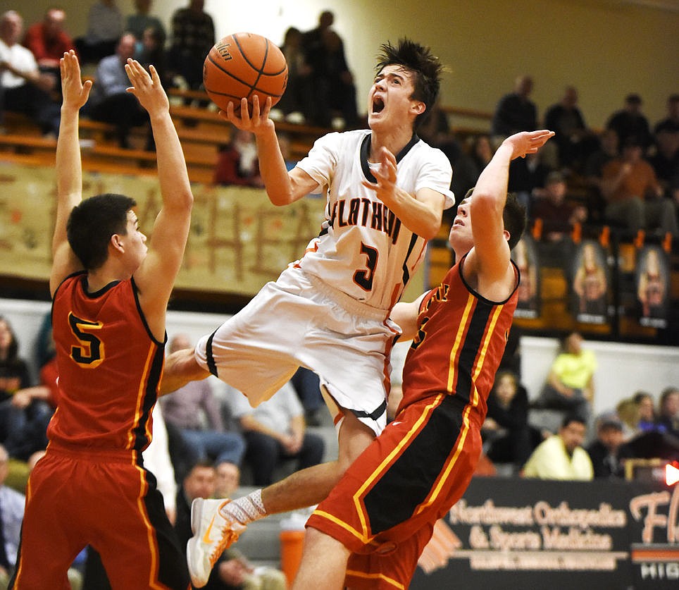 &lt;p&gt;Flathead's Matt Marshall splits Missoula Hellgate defenders Buckley Belcourt (5) and Connor Schenck as he puts up a shot during the second quarter at Flathead on Tuesday. (Aaric Bryan/Daily Inter Lake)&lt;/p&gt;