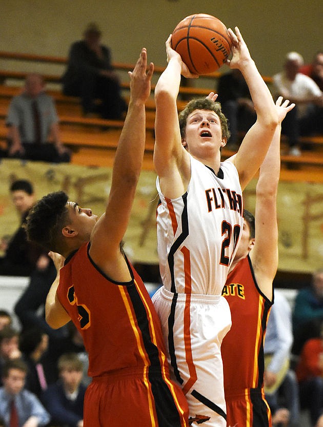 &lt;p&gt;Flathead's Bridger Johnson scores the first points of the game as he shoots over Missoula Hellgate's Landon Youbles at Flathead on Tuesday. (Aaric Bryan/Daily Inter Lake)&lt;/p&gt;