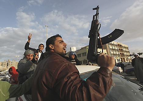 &lt;p&gt;A Libyan protester holds a weapon as he shouts slogans against Libyan Leader Moammar Gadhafi, during a demonstration in Tobruk, Libya, Wednesday Feb. 23, 2011. Thousands in the coastal town of Tobruk celebrated their freedom from Moammar Gadhafi on Wednesday by waving flags of the old monarchy, honking horns and firing guns in the air around a city square where he once executed people.&lt;/p&gt;