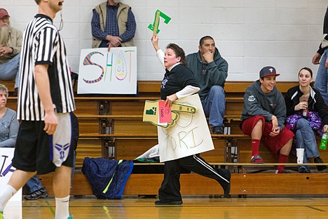 &lt;p&gt;Deanna Watkins runs to the penalty box after cheering for a player Saturday during a Rathdrum Parks and Recreation basketball game at Lakeland Junior High where parents and fans were required to show their support for players in a non-vocal manner. Fans were given a red card and sent to a penalty box if they broke their silence.&lt;/p&gt;