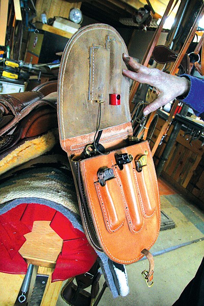 Ann Zabel shows off one of the custom saddle bags she made for a client at her workshop in Mission. Zabel has more than 40 years of experience tooling leather, and makes custom saddles and leather gear.