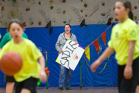 &lt;p&gt;Amanda Anderson cheers from a penalty box during a Rathdrum Parks and Recreation basketball game Saturday. Anderson was sent to the box for cheering aloud which was forbidden in order to teach parents and fans a lesson in good sportsmanship.&lt;/p&gt;